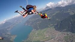 Tandem skydivers in free fall over Alps Stock Footage