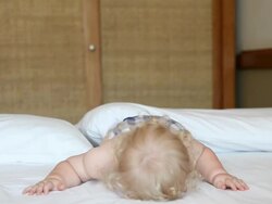 Baby boy crying on bed Stock Footage