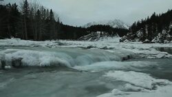Pan left across frozen frozen creek Stock Footage