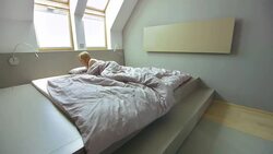 LS PAN Woman Get Up And Go To The Bathroom Stock Footage