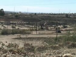 (HD1080i) Hurried Hydrocarbon Exploration: Dusty Oil Field, Wide -Time Lapse- Stock Footage
