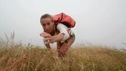 Man offering a helping hand to hiker female Stock Footage