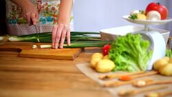 Cutting of spring onions for salad Stock Footage