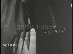 1939: EUROPE: AERIAL WS German aircraft in flight. CU Mein Kampf book opened, pages turning, superimposed German: '...Democracy is a monstrosity...', 'Borders are made by man & can be changed by man', '...will be world power, or nothing' Instructional Video