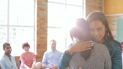 Portrait of women hugging in group therapy session Stock Footage