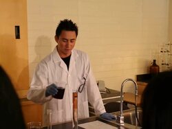 Asian Male Technician, Teacher, Professor Mixing Chemicals and Teaching Stock Footage