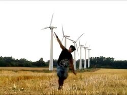 Man running near of wind turbines Stock Footage