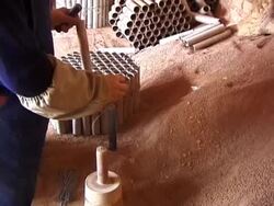 Making Fireworks Filling explosive tubes with dirt Stock Footage