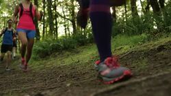 Ultra marathon runner running outdoors in the woods Stock Footage