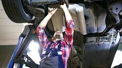 Car mechanic working under a vehicle. Stock Footage