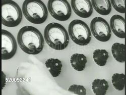 1948: U.S. LISTENING POSTS: NIGHT: LA MS Lit building windows. INT MS Engineers at large radio panel. VS CU Meters, dials. wires on switchboard. VS People working w/ typewriters, people at desks w/ papers, translating, man w/ book. Cold War, USA Instructional Video