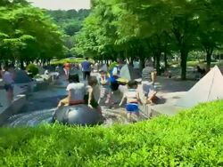 MS T/L PAN TU Kids with people playing and enjoying at Fountain at Incheon munhak Stadium / Incheon, South Korea Stock Footage