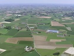 WS AERIAL ZO ZI View of Cemetery Passendale with farm land / Flanders, Belgium Stock Footage