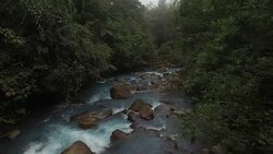AERIAL Rio Celeste with surrounding rainforest in fog Stock Footage