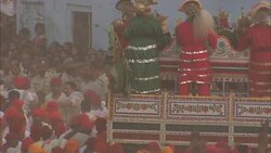 Costumed participants are held aloft as they move through a dense crowd during India's Diwali celebration. Stock Footage