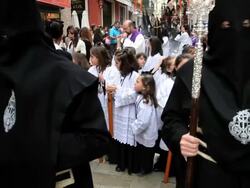 Children in a Religious procession with the Nazarenos, Semana Santa, Malaga, Andalucia, Spain, Europe Stock Footage