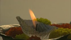 A lighted candle floats on a river. Stock Footage