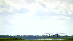 Propeller plane landing on runway Stock Footage