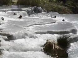 WS Shot of People relaxing in hot spring, thermal pools of sulphurous water / Saturnia, Tuscany, Italy Stock Footage