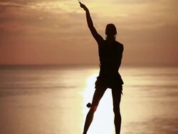 MS Sihouetted female poi dancer performing in front of fiery sunrise sky and ocean / Montezuma, Costa Rica Stock Footage