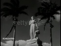 1940: MARTINIQUE: HA WS Martinique harbor & town, buildings up hillside. Fort de France statue of Empress Josephine (head in tact). VS French buildings, guards walking behind open gate, standing at attention w/ bayonet rifles. Instructional Video