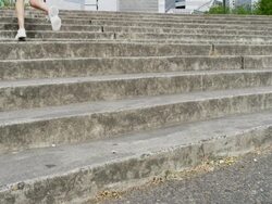 MS SLO MO Shot of young female jogger running up steps out of frame / Portland, Oregon, United States  Stock Footage