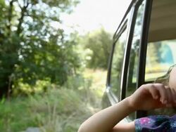 Girl in a car window, talking and looking up Stock Footage