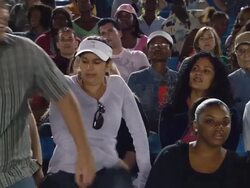 MS Man walking in front of crowd in bleachers while talking on his cell phone / Homestead, FL, USA Stock Footage