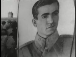 A newspaper headline read  Mossadegh Flees Iran Riots,  Shah Prepares Flight Home as the  Shah of Iran Mohammed Reza Pahlavi reads a  document. Stock Footage