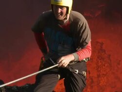 Climber prepares to descend into active volcano and lava lake, Marum Volcano, Ambrym Island, Vanuatu Stock Footage