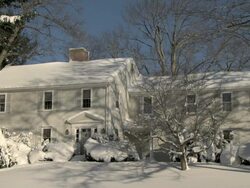 Colonial-style home covered in snow - medium Stock Footage