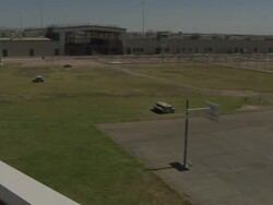 High Angle pan-right - A track surrounds a prison yard with a basketball court in California. / California, USA Stock Footage