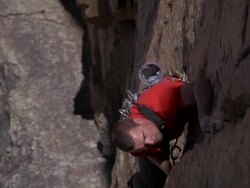 MS ZO Shot of male climber climbing rock with man is in sun shade line / Estes Park, Colorado, United States Stock Footage