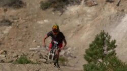 Teenage boy mountain biker doing tricks off dirt jumps. Stock Footage