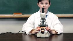 Child looking through microscope Stock Footage
