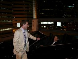 MS TD Two well dressed young man standing together on modern convertible car at night in urban area laughing and smiling / Minneapolis, Minnesota, United States Stock Footage