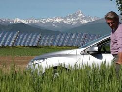 Couple leave car in green field beside solar cell plant Stock Footage