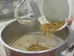 Putting fresh walnut into dough Stock Footage