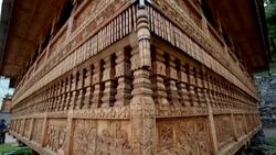 Pan up shot of ornately carved wooden Hindu Temple. Stock Footage