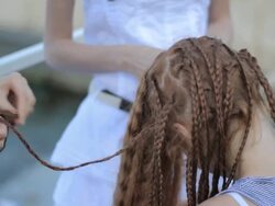 process of unbraid braids on red-haired teenage girl Stock Footage