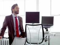 MS businessman standing in discussion at table in office workstation Stock Footage