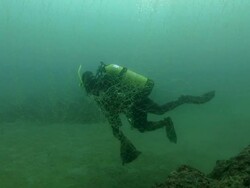 Scuba diver trapped in fishing net Stock Footage