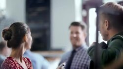 Young couple shop in local clothing store, pose for smartphone photo with striped sweater Stock Footage