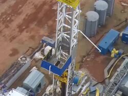 CU AERIAL DS Shot of derrick of oil drilling rig in Bakken oil field near Watford City / Watford City, North Dakota, United States Stock Footage