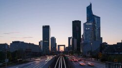 Paris road leading towards La Grand Arche and modern office buildings at La Defense, Paris, France - Time lapse Stock Footage