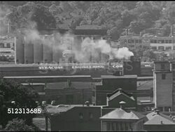 1951: SYRACUSE, NEW YORK: INDUSTRY: WS Industrial tanks, traffic passing. HA WS Above Syracuse Engineering Company w/ smoking chimney. WS Manufacturing factory warehouses. CITYSCAPE: WS Loew's theater w/ 'The Law and the Lady' on marquee, WS Downtown. Instructional Video