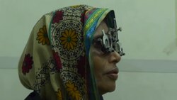 An elderly woman has an eye examination and test by an optician before being given new glasses by a healthcare NGO in rural Bangladesh operating from a hospital ship Stock Footage