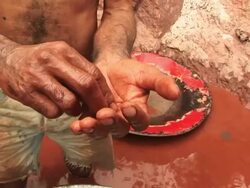 CU Shot of gold miner's hand with mercury and gold / Jacobina, Bahia, Brazil Stock Footage