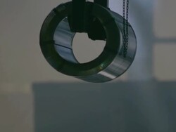 MS TS Shot of Roll of steel being hoisted up by crane Stock Footage