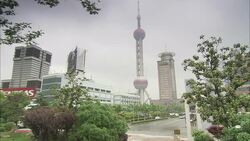 A bus passes below Oriental Pearl Tower in Shanghai, China. Stock Footage